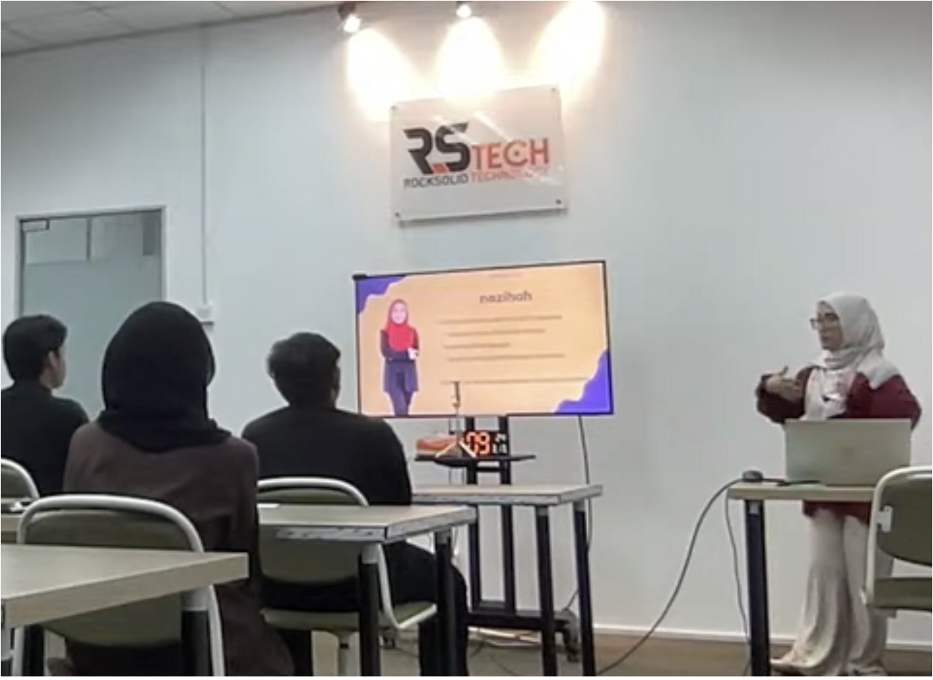 Trainer presenting branding tactics to corporate attendees
